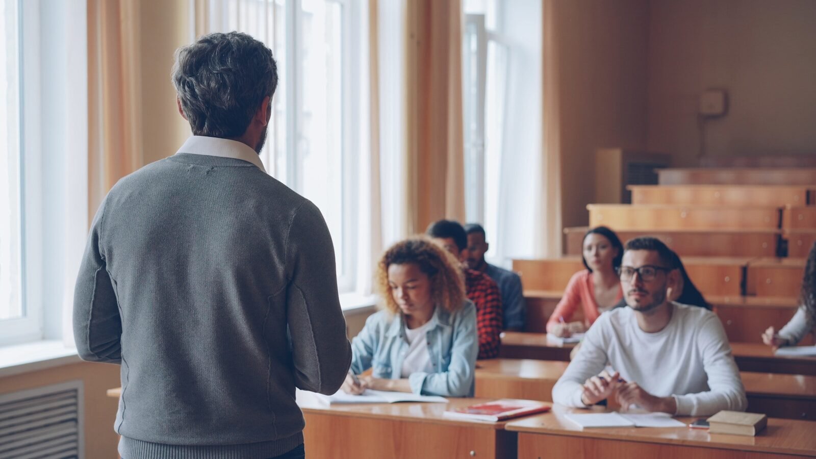 Professor teaching students in a lecture hall